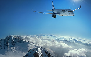 passenger plane flying under mountain cliff close up photography