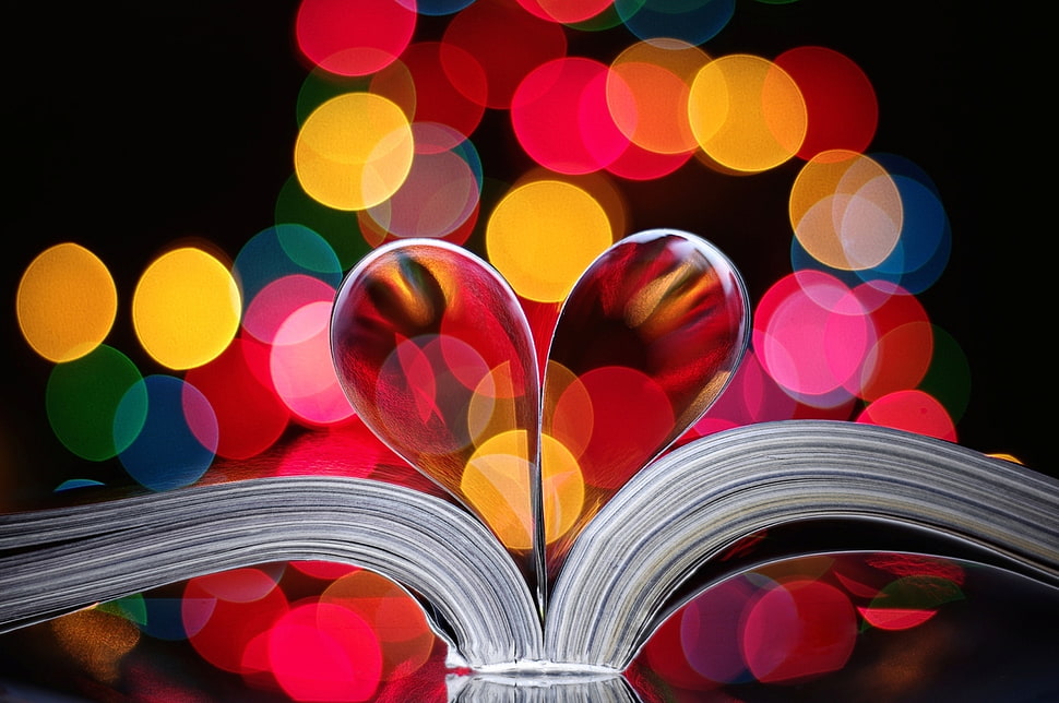 two book pages shaped into heart with bokeh light background HD wallpaper