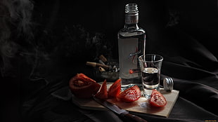 clear glass liquor bottle and shot glass, lunch, alcohol, tomatoes, knives