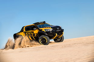 black and yellow Tonka printed Toyota crew-cab pickup truck on desert