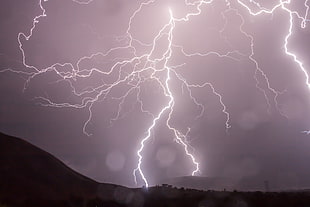 lighting strikes with silhouette of mountain during night HD wallpaper