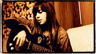 woman in gray jacket playing guitar HD wallpaper
