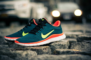 green-and-orange Nike lace-up low-top sneakers