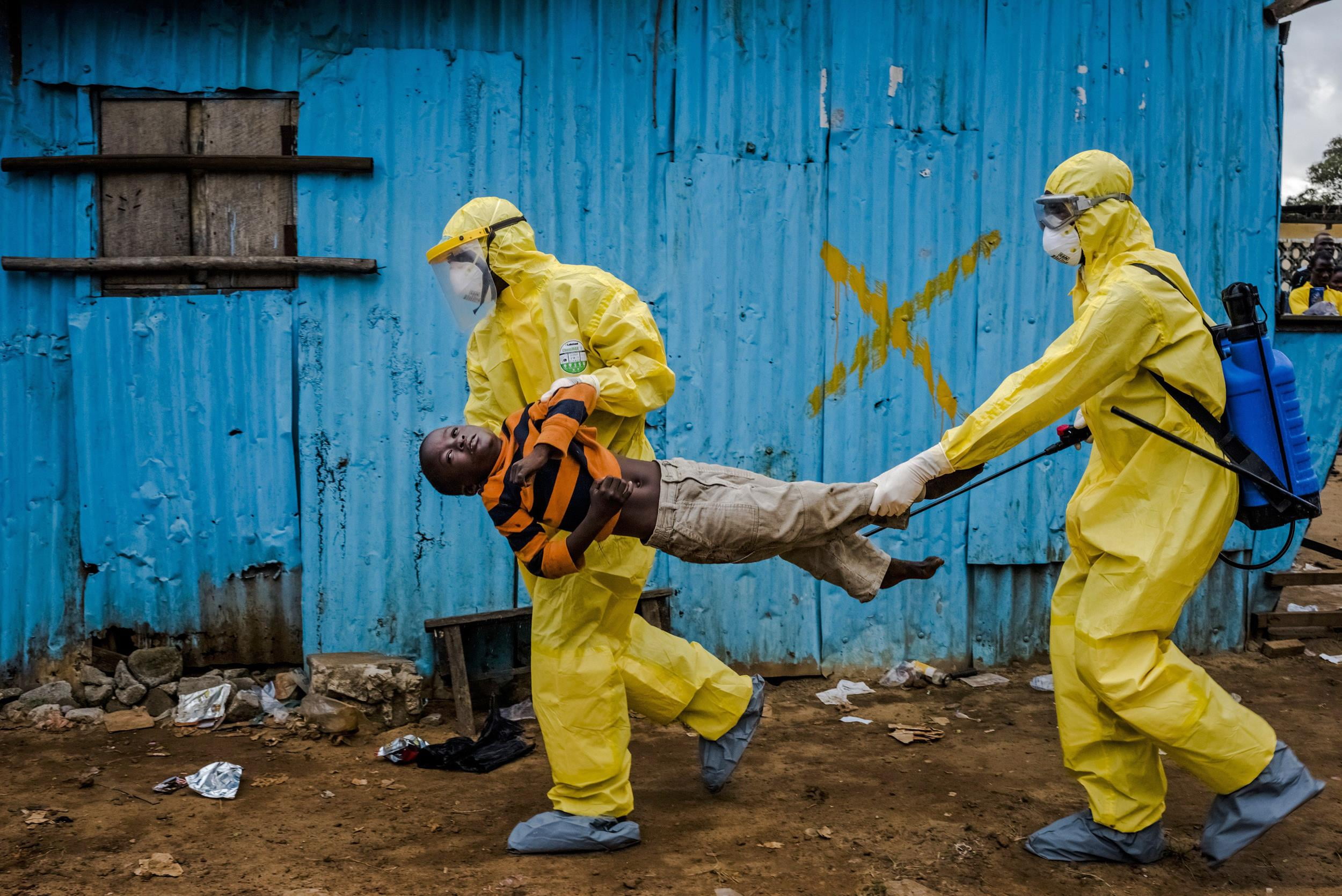 two men on yellow suit carrying a boy