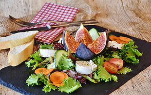 vegetable salad served on black tray
