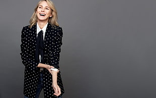woman wearing black and white dotted print coat