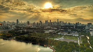 aerial view of city buildings during yellow sunset, bangkok