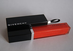 Givenchy glass bottle with box on top of white surface