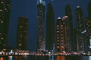 low angle photography of high rise buildings at night