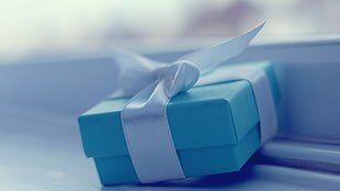 teal gift box with white ribbon lace