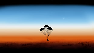 silhouette of triangular case with three parachutes during daytime, landscape, Apollo