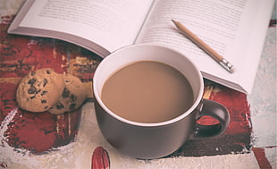 white ceramic mug, coffee, books