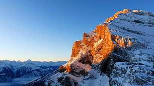 structural shot of white snowy mountain during sunrise