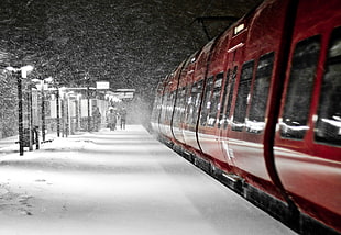 red train on snowy station