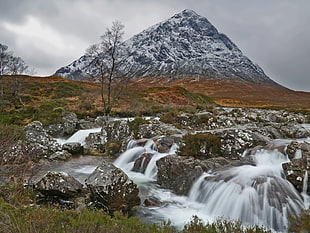 time lapse photography of waterfalls near mountain peak, scotland