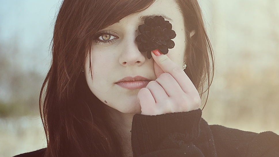 woman wearing black sweater covers her eye with a black flower HD wallpaper