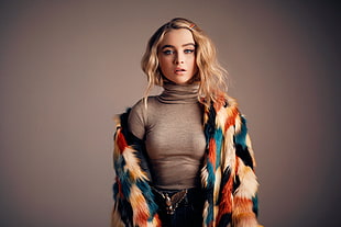 woman wearing gray turtle-neck top with multicolored fur coat