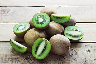 bunch of Kiwi on brown wooden surface