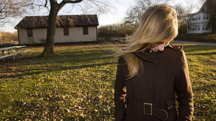 shallow focus photography of blonde haired woman in brown coat