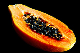 slice of papaya with black background