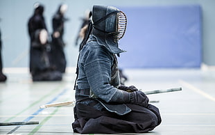 person wearing gray kendo suit