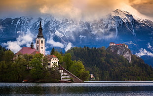 church near body of water and mountain during daytime