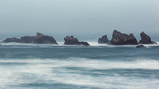 panoramic photography of rocks on ocean