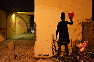 person painting heart on wall near hallway
