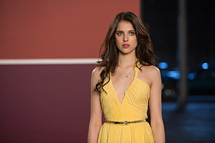 woman wearing yellow halter dress