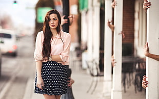 woman wearing white bell-sleeves blouse with black and white polka skirt