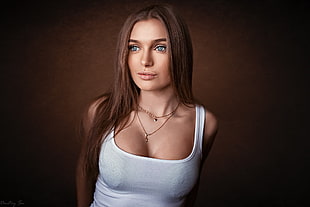 brown haired woman in white tank top