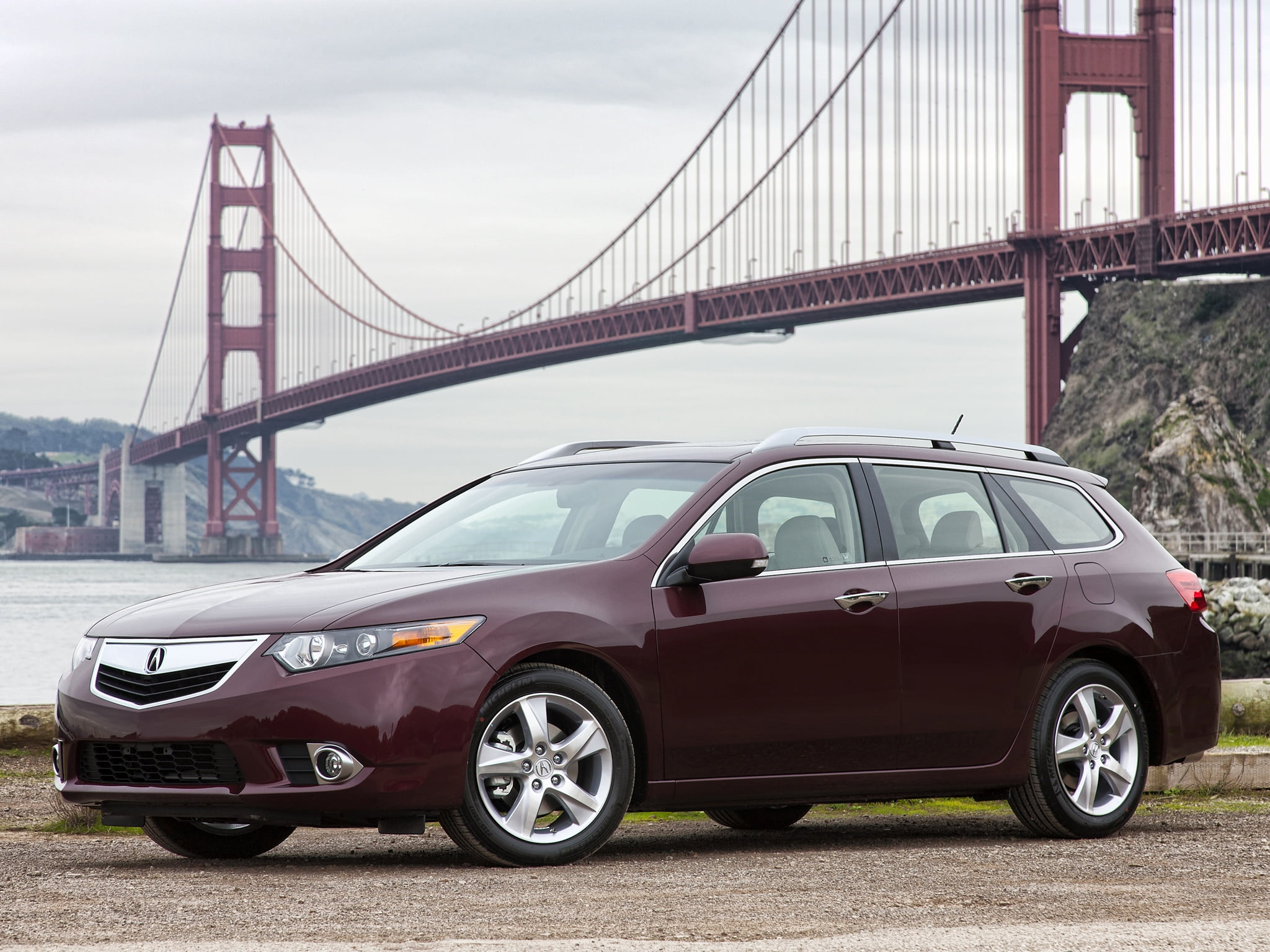 red Acura TL station wagon near bridge at daytime