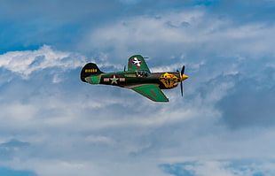green and yellow plane flying