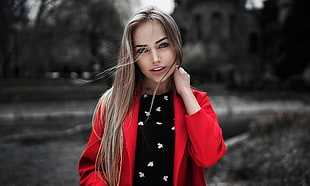 woman in red coat posing for photo
