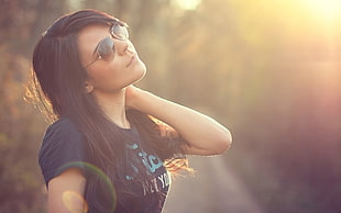 woman wearing brown aviator sunglasses photo taken during golden hour in selective focus photography