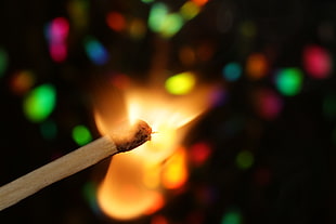 shallow focus photography of burning match stick
