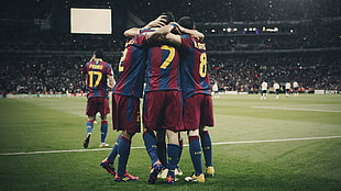 group of soccer playing having a group hug HD wallpaper
