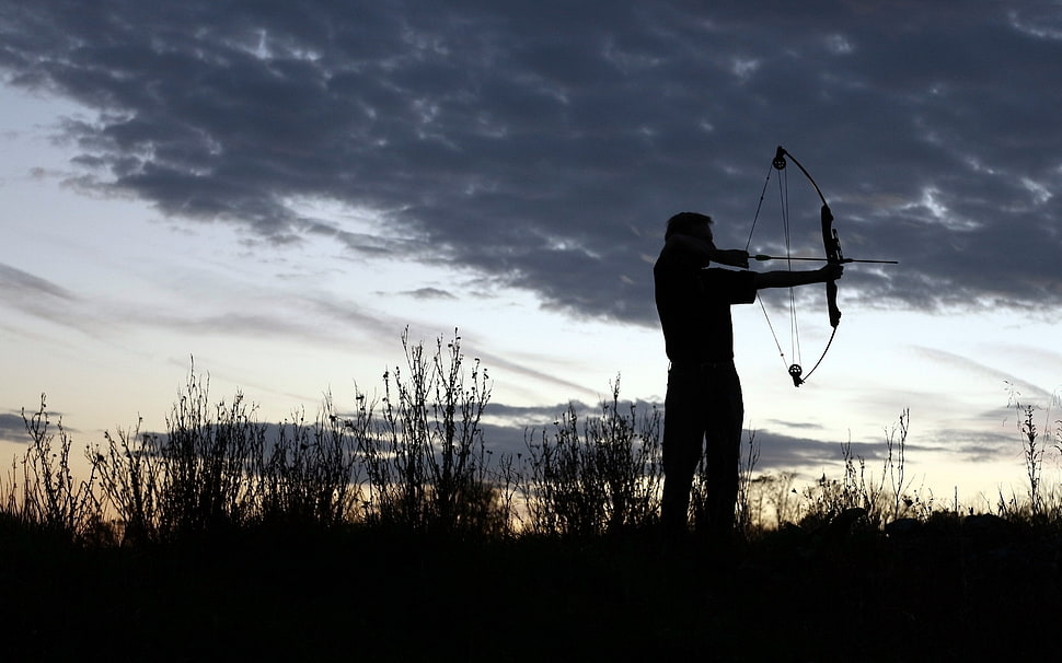 silhouette of man holding bow HD wallpaper