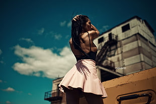focus photo of woman in black and pink spaghetti strap dress