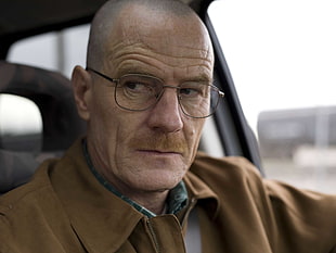 man in brown jacket with full-frame eyeglasses