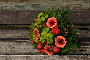 red flower and green leaves bouquet