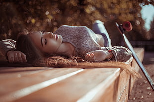 woman lying on floor with skateboard during daytime HD wallpaper