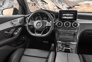 black Mercedes-Benz multi-function steering wheel