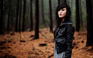 woman in black leather jacket background with trees