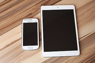 white Samsung smartphone and white iPad