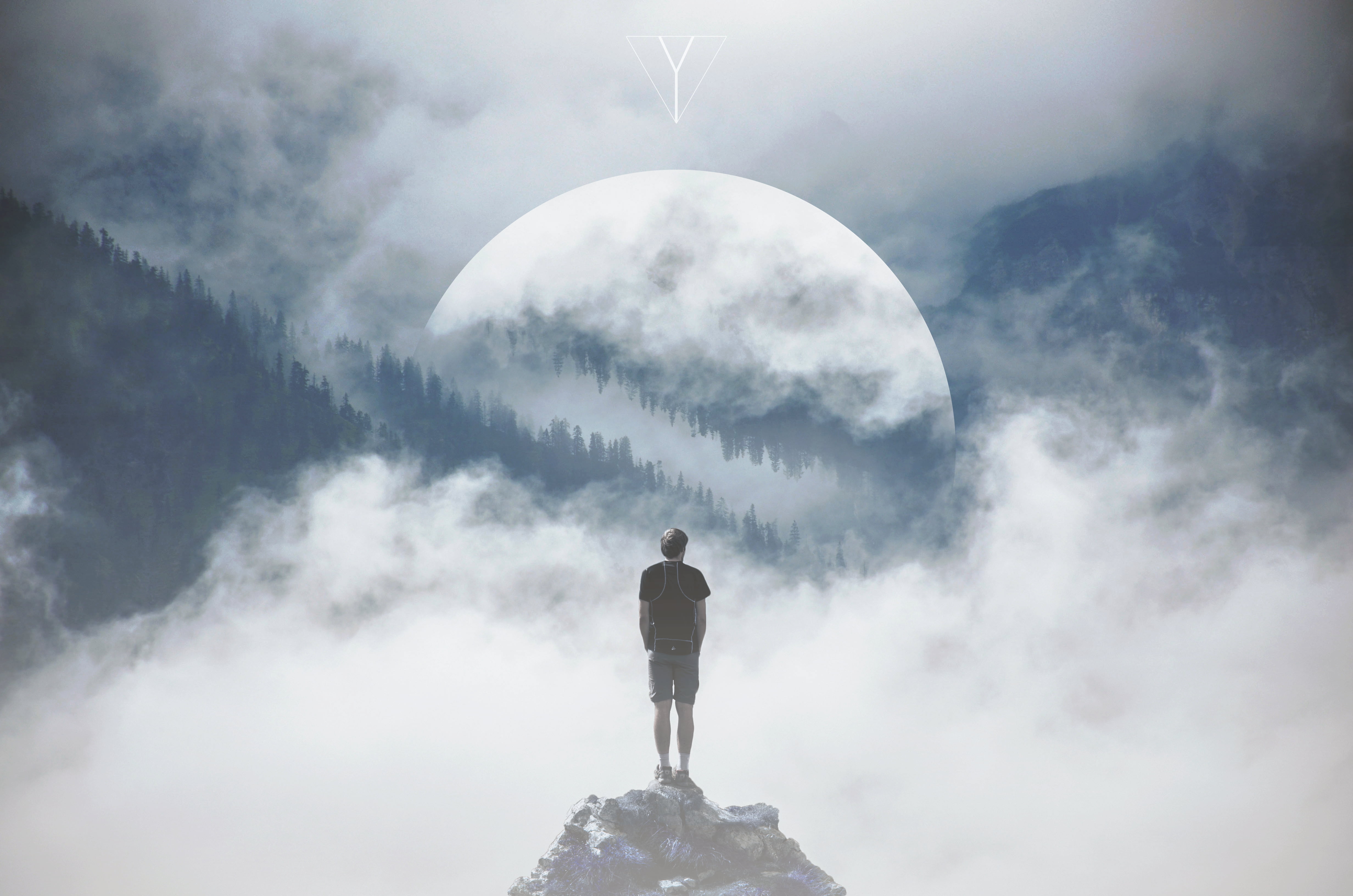 painting of person standing on the edge of cliff facing the moon
