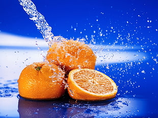 macro photography of orange fruits on water