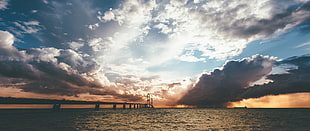 silhouette of concrete bridge, sea, clouds HD wallpaper