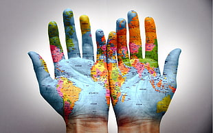 world map painting on human hand