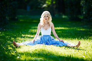 woman in white spaghetti strap top sitting on grass during daytime HD wallpaper